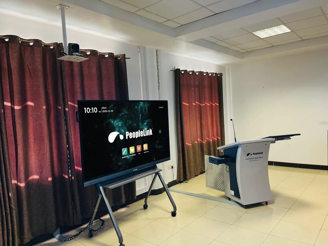 Trolley mounted display beside a podium in a training room
