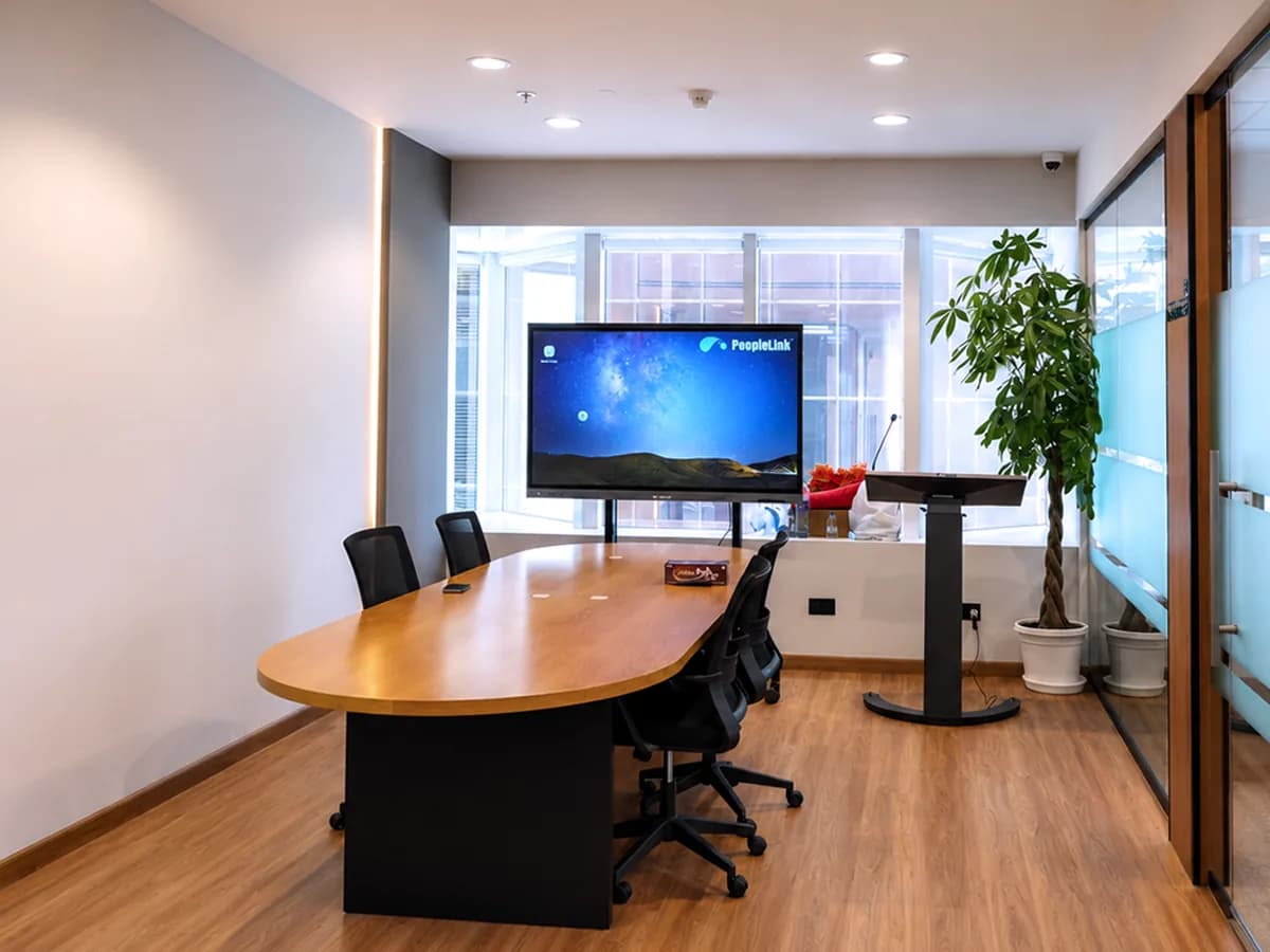 Bright showroom meeting room with interactive display and PTZ camera