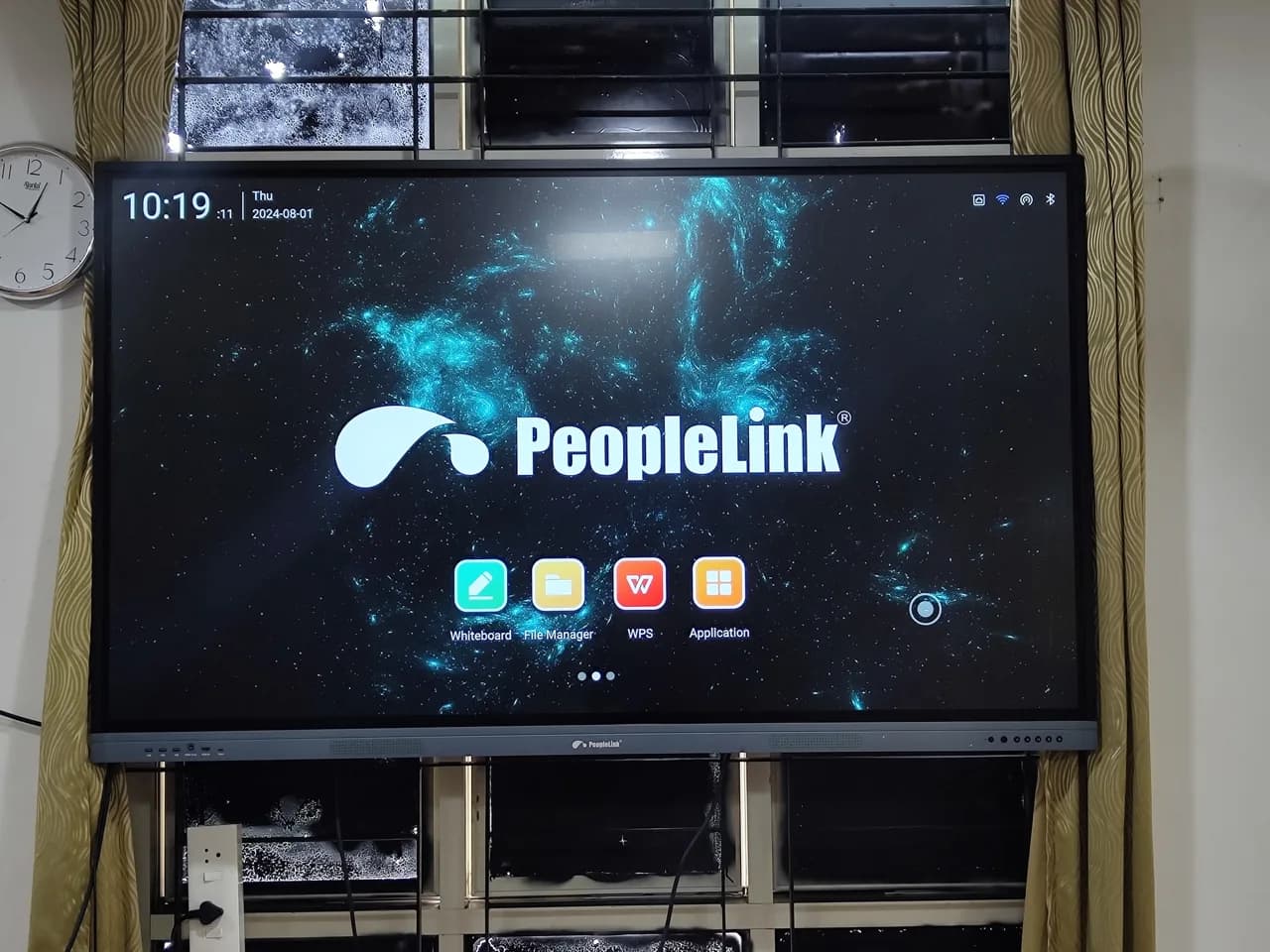 Close view of a PeopleLink interactive display on a wall mount