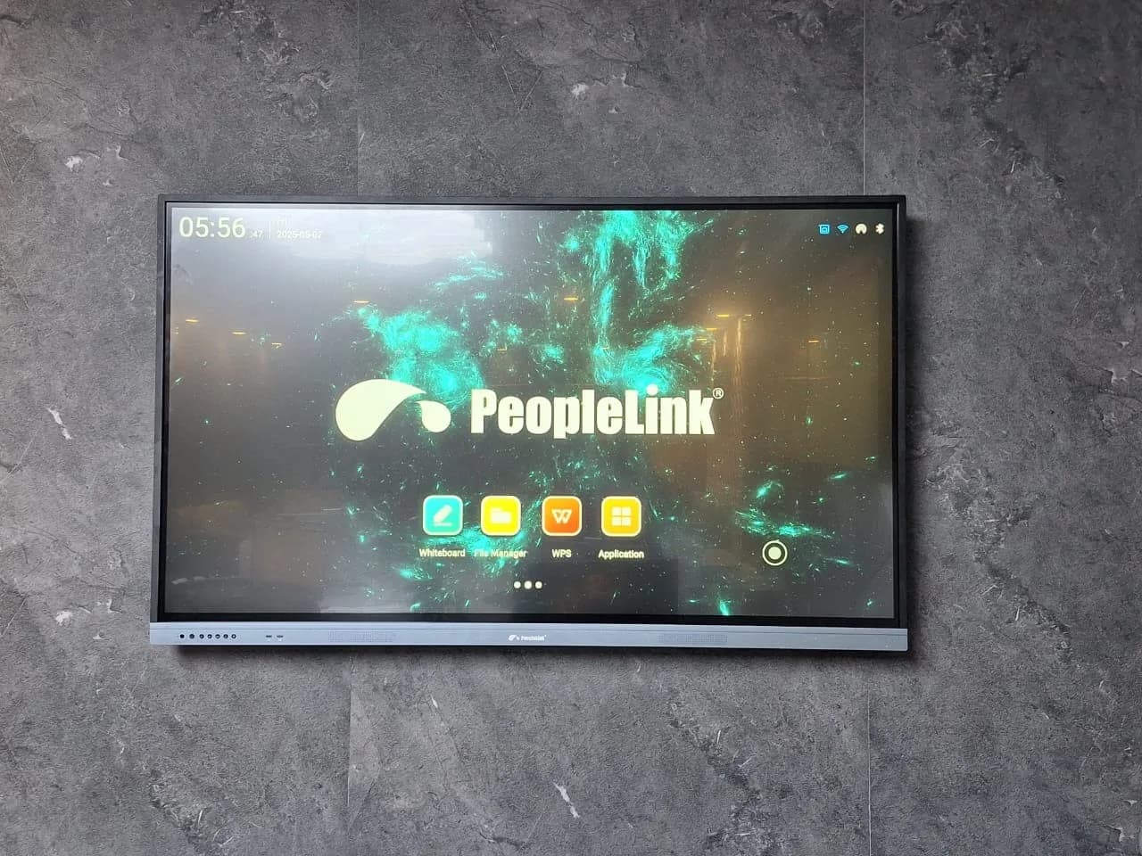 PeopleLink interactive display mounted on a stone wall