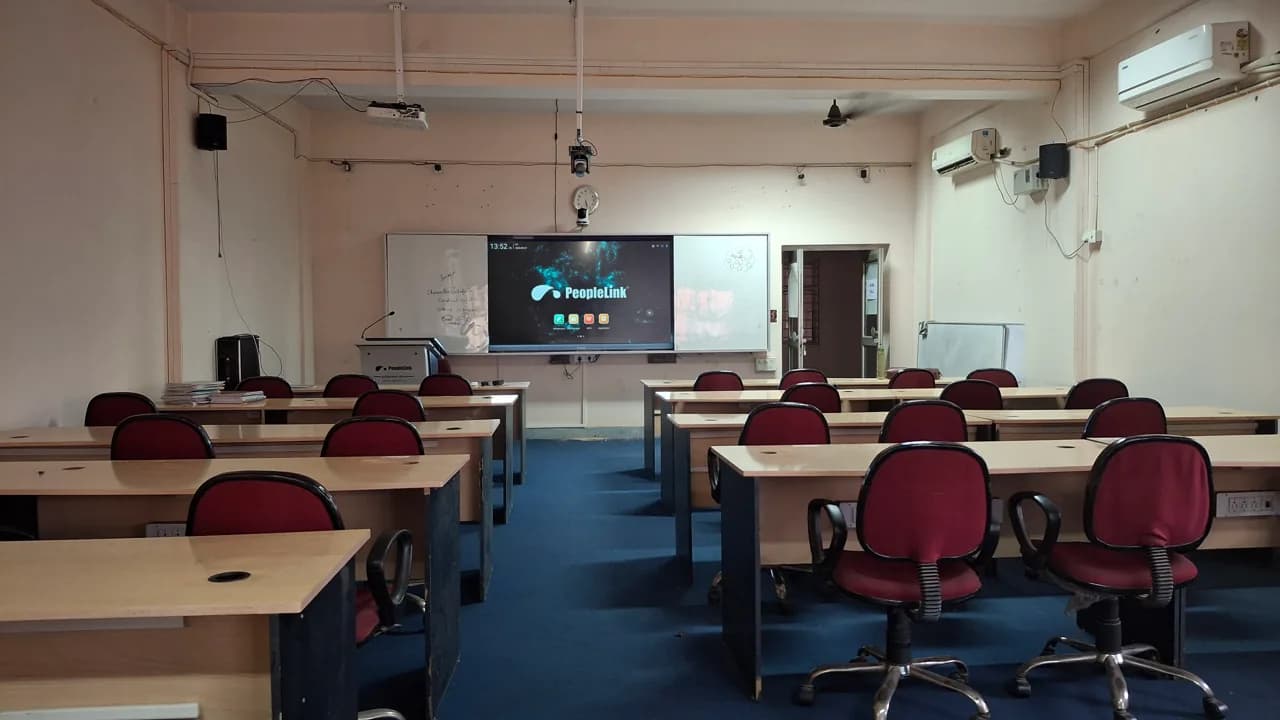 Classroom with red chairs and a PeopleLink interactive display at the front