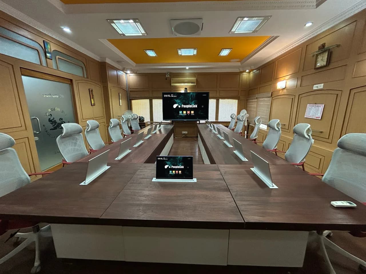 Conference table with branded retractable delegate monitors