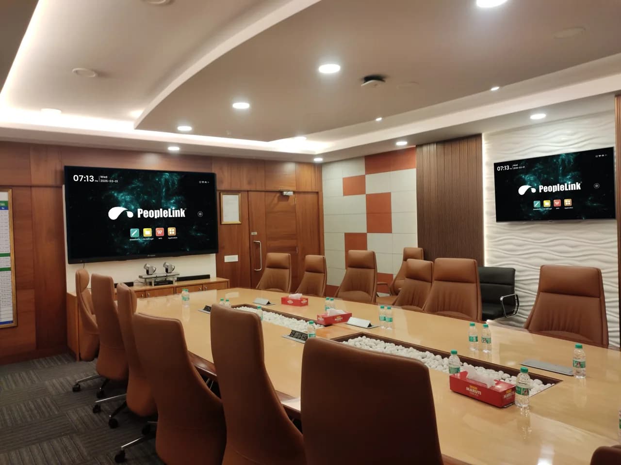 Wood-panelled bank boardroom with dual PeopleLink displays